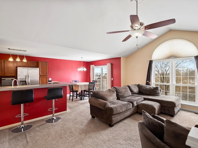 living area with ceiling fan, carpet, and vaulted ceiling