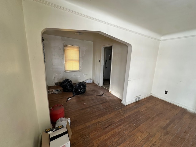 spare room featuring crown molding and hardwood / wood-style floors