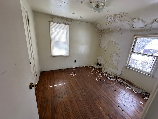 unfurnished room featuring plenty of natural light and hardwood / wood-style floors