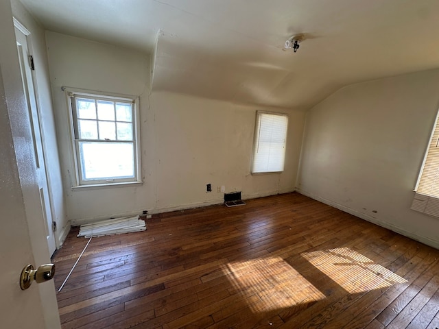 empty room with lofted ceiling and dark hardwood / wood-style floors