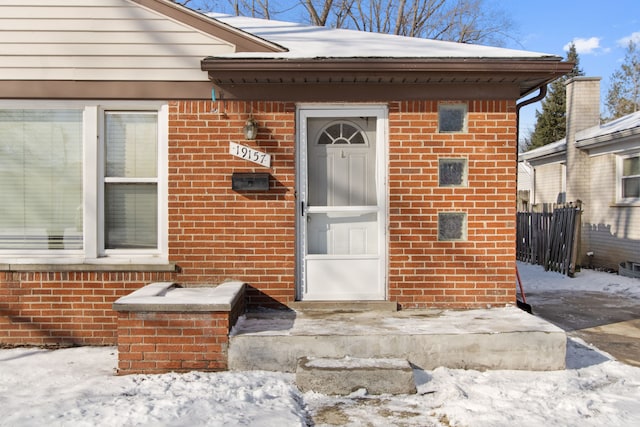 view of snow covered property entrance