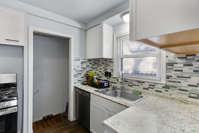 kitchen with gas stove, black dishwasher, sink, and white cabinets