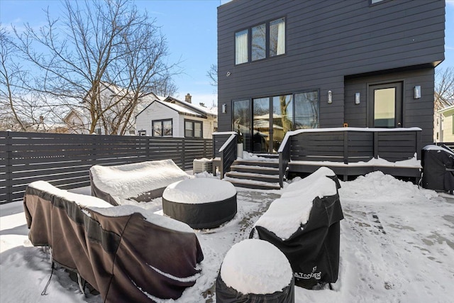 snow covered patio with fence