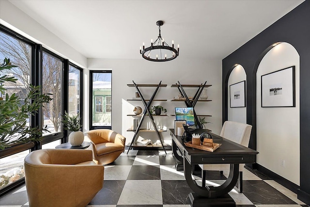 office with baseboards and a notable chandelier