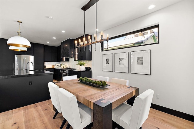 dining area featuring light wood-type flooring, baseboards, and recessed lighting