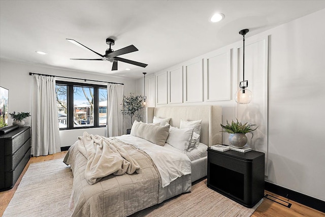 bedroom featuring baseboards, light wood-type flooring, a ceiling fan, and recessed lighting