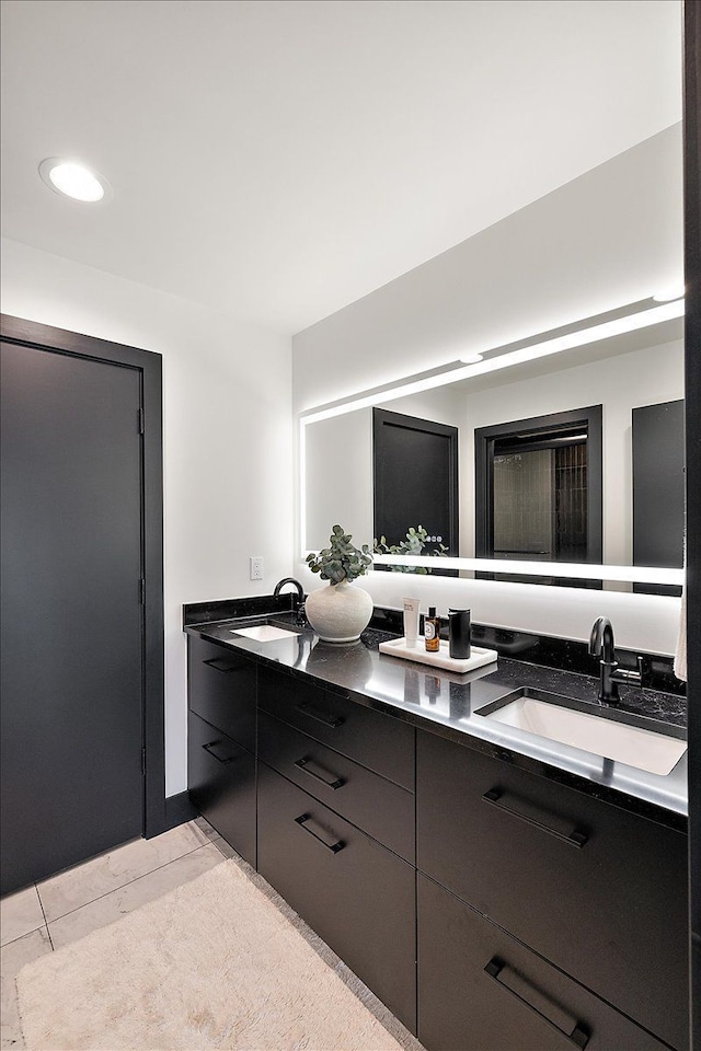 full bath featuring double vanity and a sink