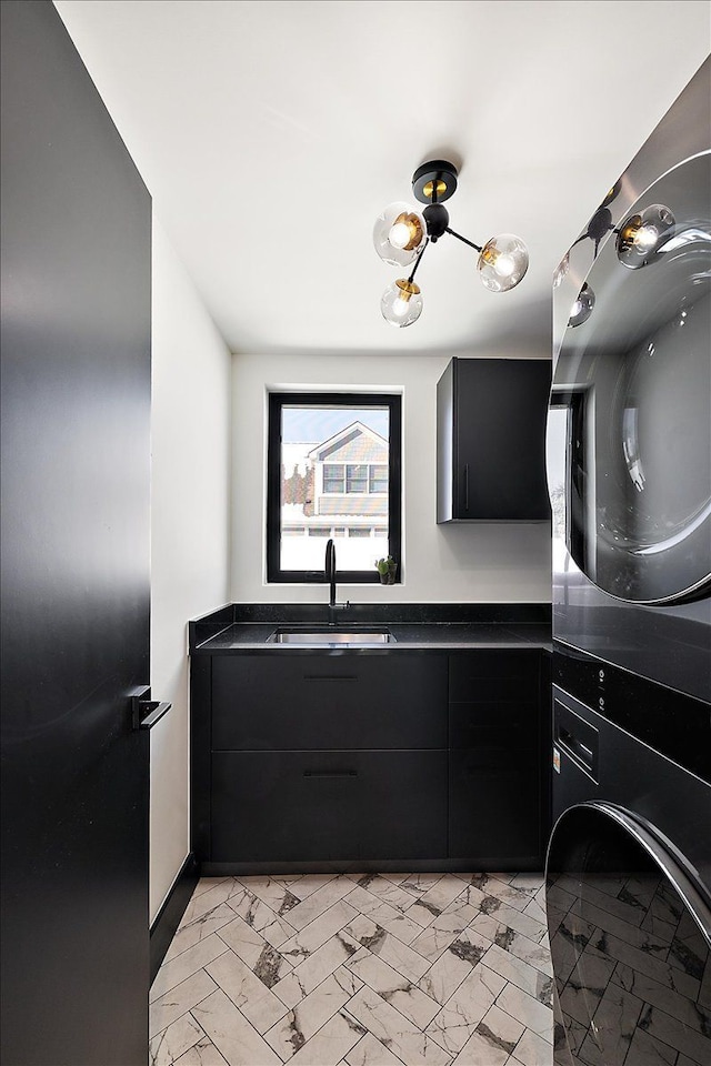 bathroom with marble finish floor, vanity, and stacked washing maching and dryer