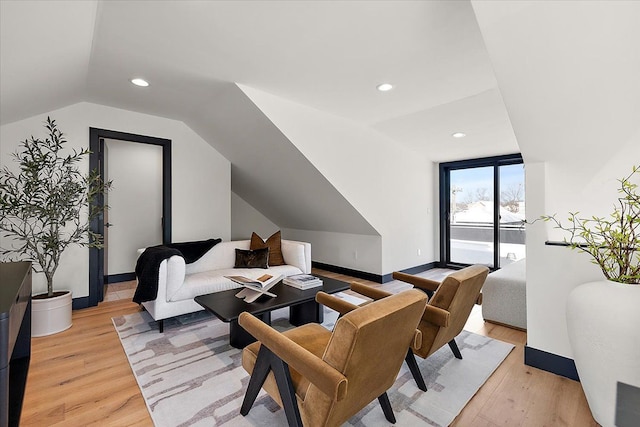 living area featuring light wood-type flooring, vaulted ceiling, baseboards, and recessed lighting