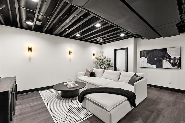 living area featuring baseboards and dark wood finished floors