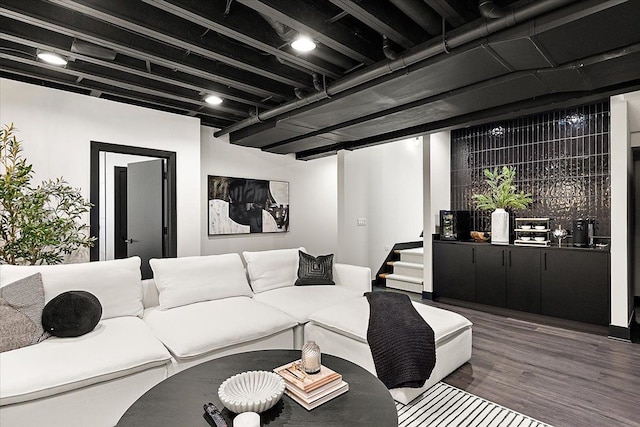 living room with stairs and dark wood-type flooring