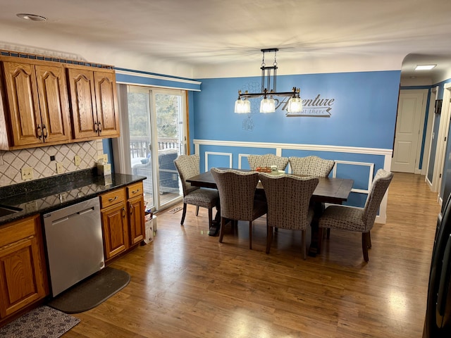 dining area with hardwood / wood-style flooring and a chandelier