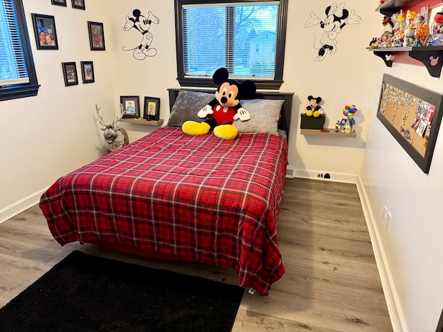 bedroom with hardwood / wood-style flooring