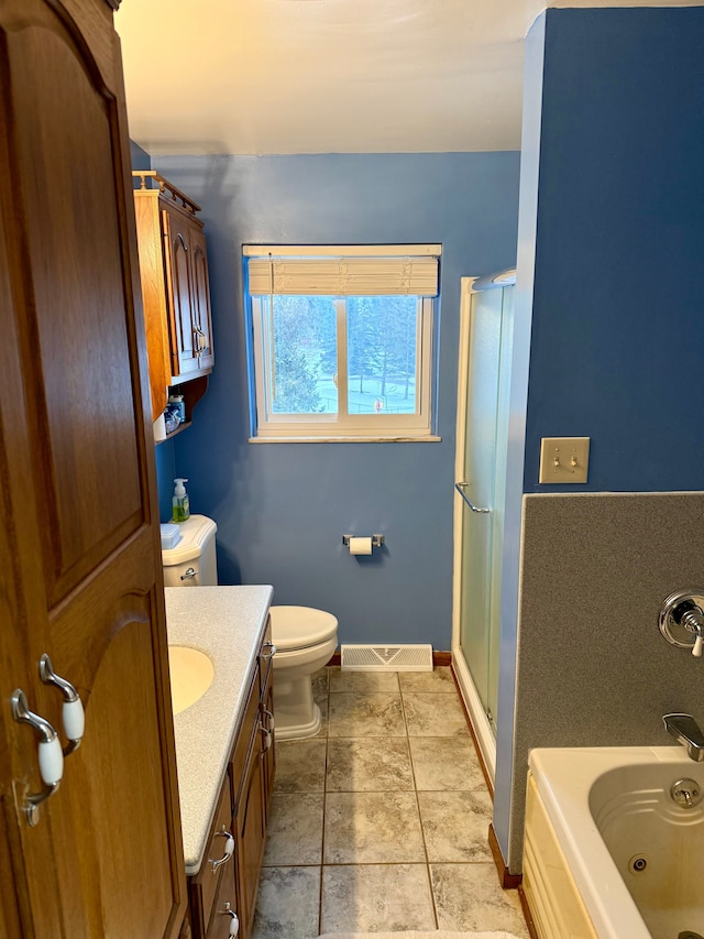 full bathroom featuring tile patterned flooring, vanity, separate shower and tub, and toilet