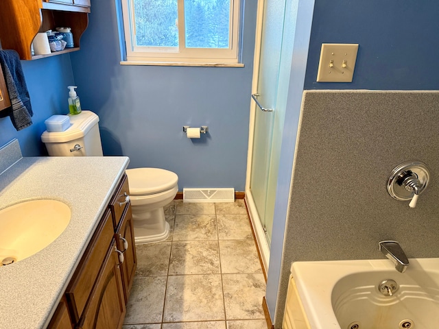 bathroom featuring tile patterned flooring, vanity, a bath, and toilet