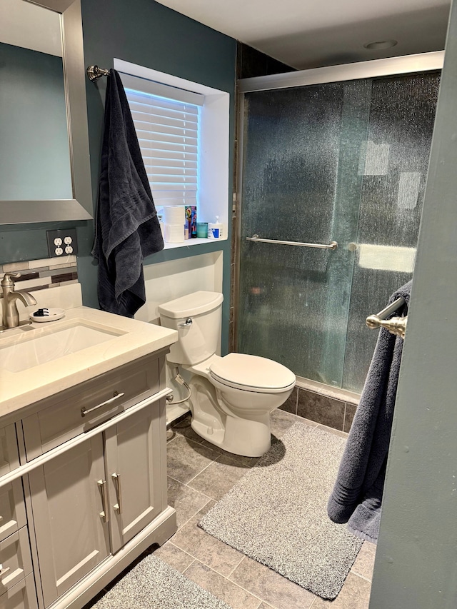 bathroom featuring vanity, toilet, and walk in shower