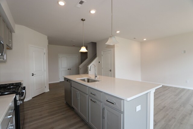 kitchen featuring a sink, appliances with stainless steel finishes, and gray cabinetry