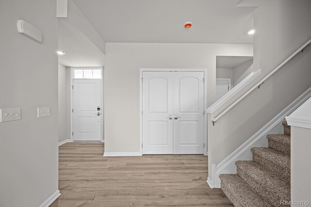 2302 Mill Ln, Saline, MI 48176 - foyer entrance with baseboards, light wood-type flooring, and stairway
