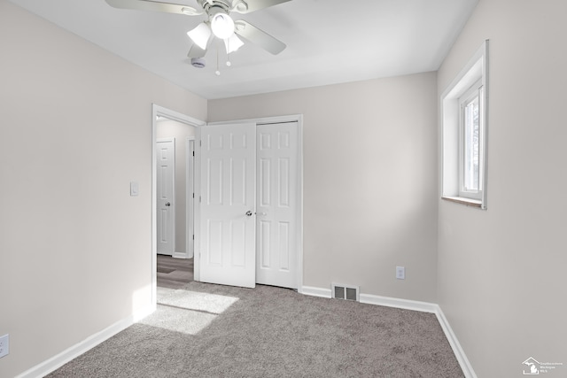 unfurnished bedroom with a closet, ceiling fan, and carpet