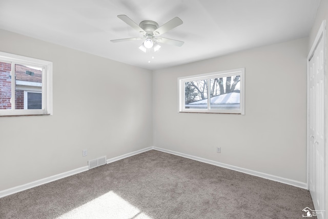 unfurnished bedroom with carpet flooring, ceiling fan, and a closet