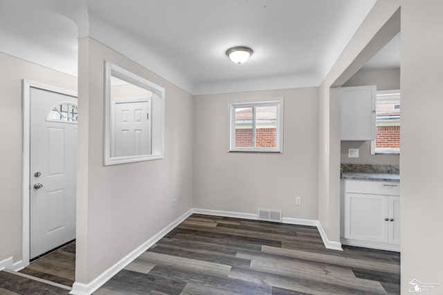 unfurnished dining area with dark hardwood / wood-style floors