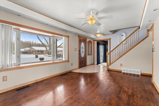 entryway with hardwood / wood-style flooring, ceiling fan, and a textured ceiling