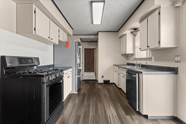 kitchen featuring stainless steel appliances, white cabinetry, sink, and dark wood-type flooring