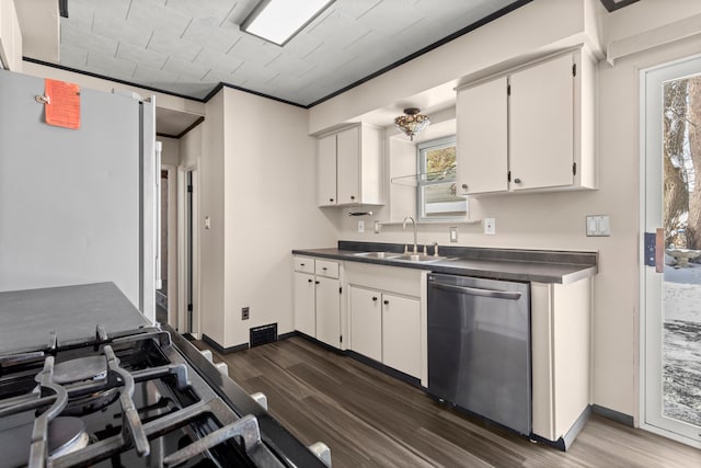 kitchen featuring sink, crown molding, white cabinetry, dark hardwood / wood-style flooring, and stainless steel dishwasher