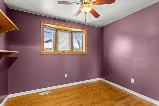 spare room with hardwood / wood-style floors and ceiling fan