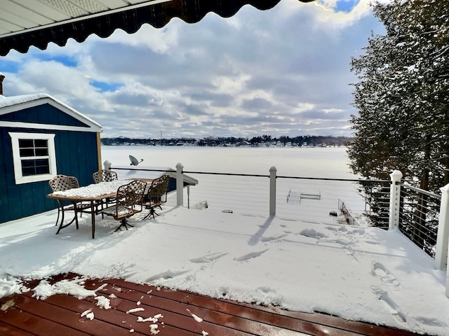 snow covered deck with a shed