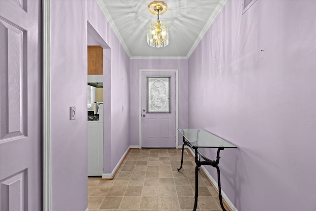 entryway with ornamental molding and a chandelier