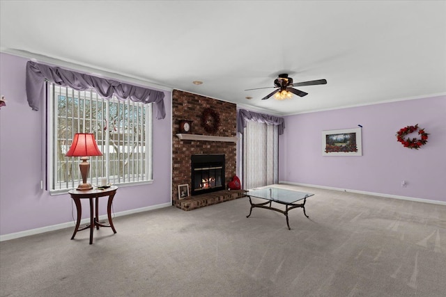 living room featuring ornamental molding, ceiling fan, carpet, and a brick fireplace