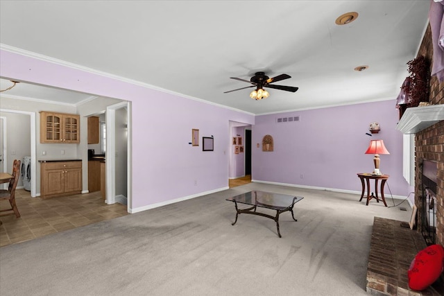 carpeted living room with a fireplace, ornamental molding, and ceiling fan