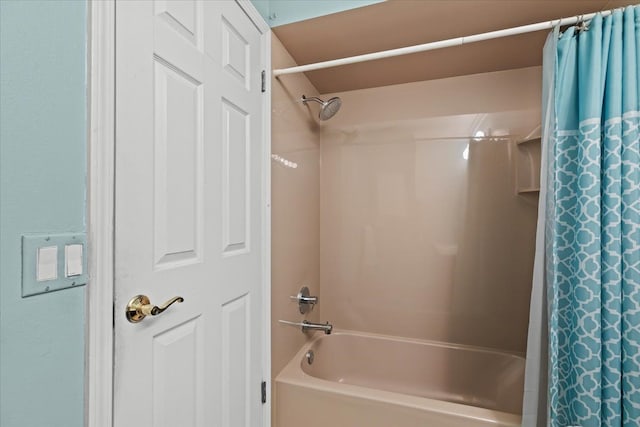 bathroom with shower / bath combo with shower curtain