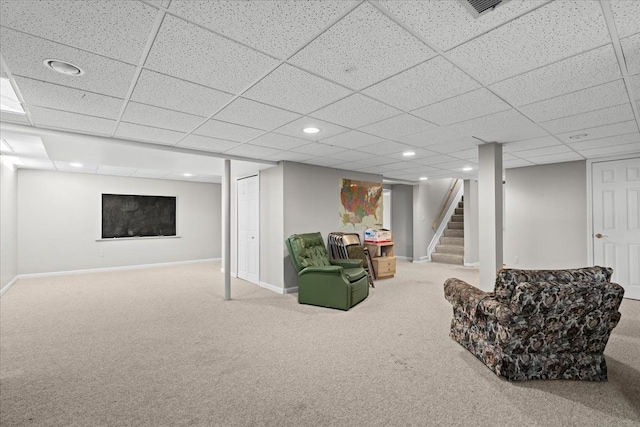 sitting room with carpet and a drop ceiling