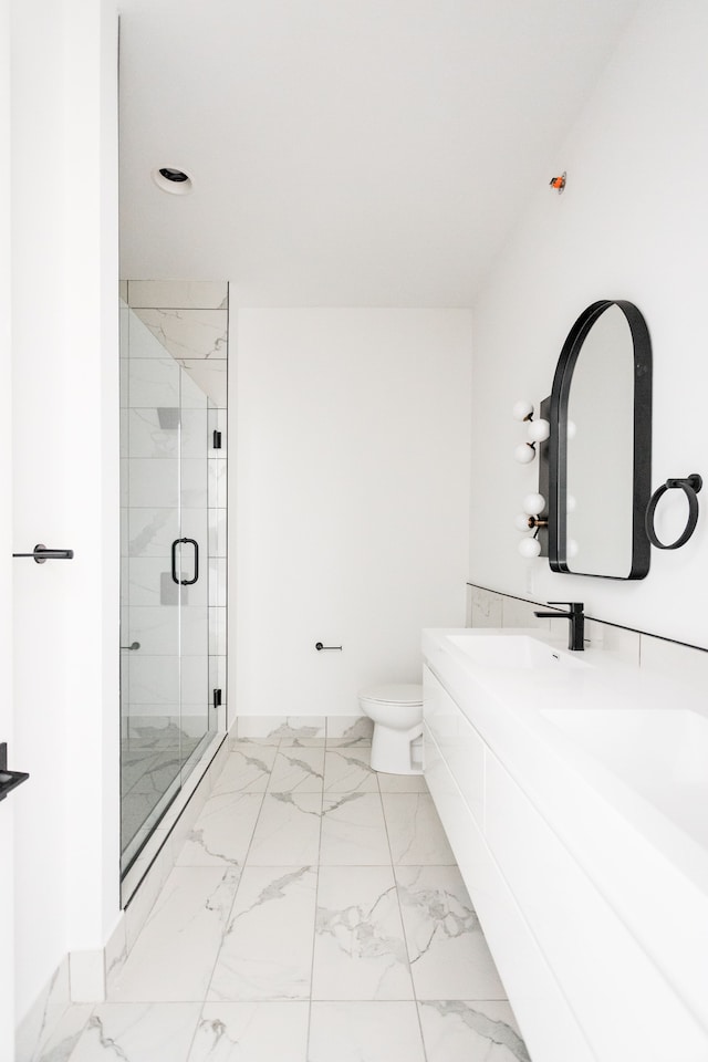 bathroom featuring walk in shower, vanity, and toilet