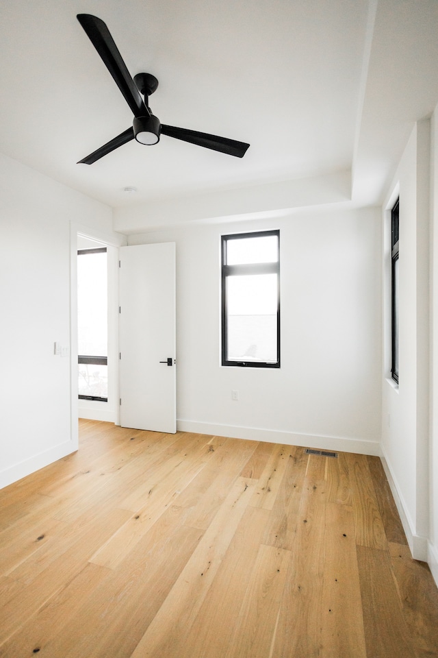 spare room featuring ceiling fan and light hardwood / wood-style flooring