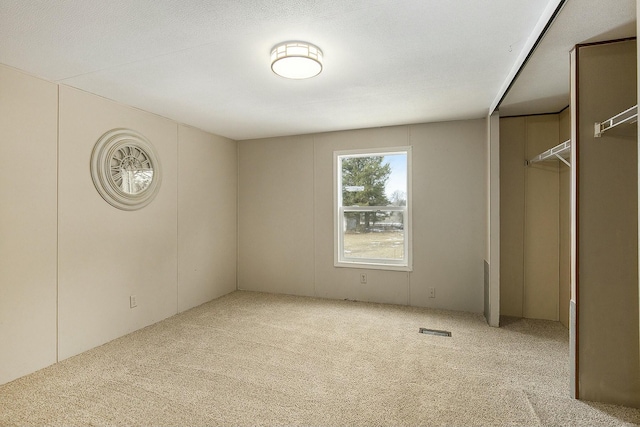 unfurnished bedroom with light colored carpet