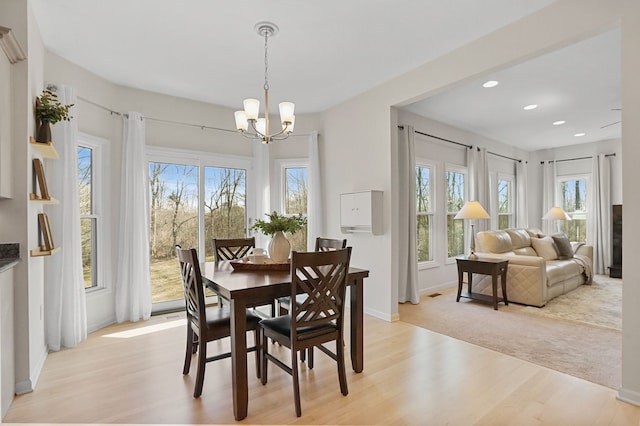 dining room featuring recessed lighting, baseboards, light wood-style floors, and a chandelier