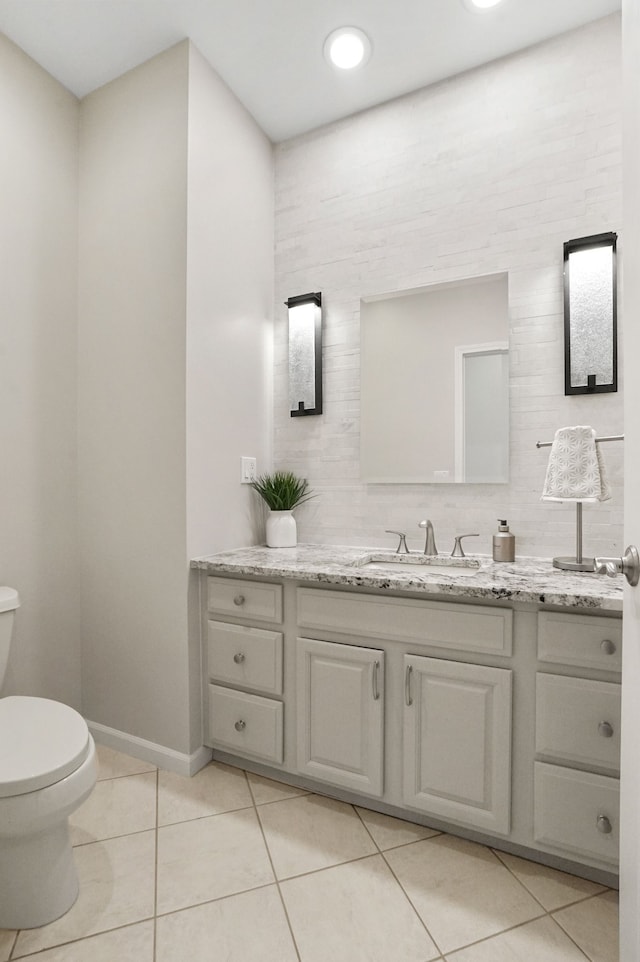 bathroom with tile patterned floors, toilet, and vanity