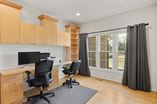 office space featuring plenty of natural light, light wood-style floors, recessed lighting, and baseboards