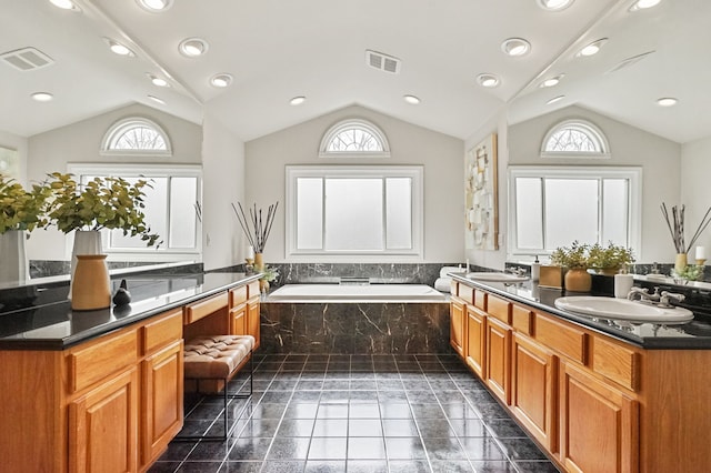 full bath with a garden tub, visible vents, and a sink