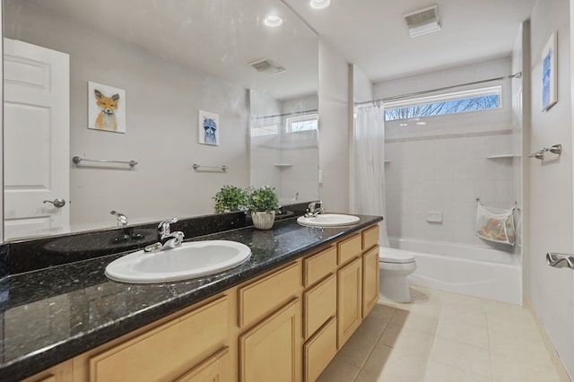 bathroom featuring visible vents, plenty of natural light, and a sink