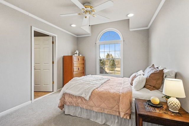 carpeted bedroom with recessed lighting, a ceiling fan, baseboards, and ornamental molding