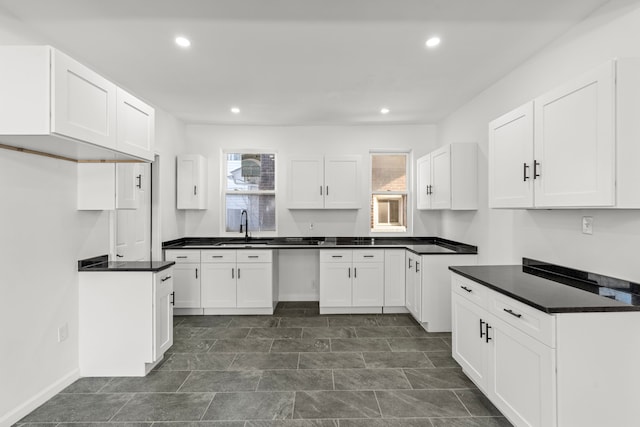 kitchen featuring sink and white cabinets