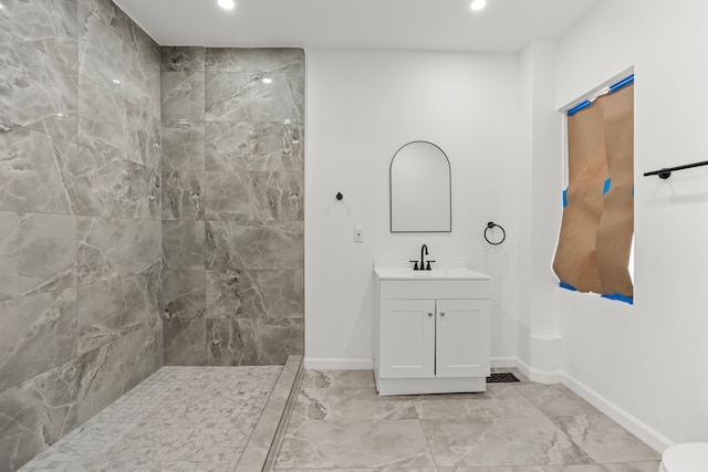 bathroom featuring vanity and tiled shower