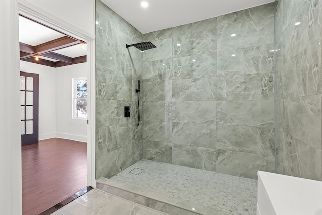 bathroom featuring beamed ceiling, coffered ceiling, and a tile shower