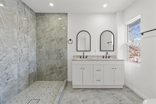 bathroom featuring vanity and a tile shower