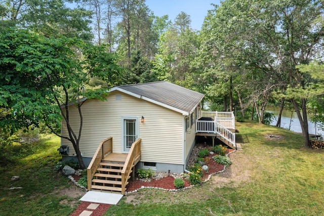 exterior space featuring a water view and a lawn