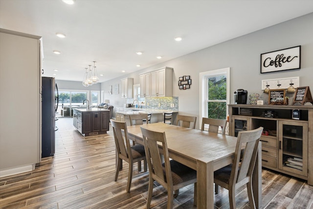 dining room with plenty of natural light, dark hardwood / wood-style floors, and a chandelier